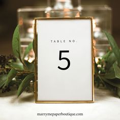 a table number is placed in front of some greenery