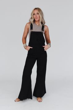 The ultimate wide leg jumpsuit is here, the Milly Distressed Hem Wide Leg Overalls! You are going to wear these year - round because of the comfortable denim fabric, the perfect wide leg silhouette, distressed details throughout for added style, functional pockets, and classic overall - style adjustable straps. Pair with a cute top like the High Neck Racerback Brami for a boho - chic look ready for any occasion. *Due to lighting and differences in monitors, actual colors may vary slightly from w How To Dress Up Overalls, Cute Outfits With Overalls, What To Wear With Overalls, Fitted Overalls, Black Overalls Outfit, Styling Overalls, Western Boho Outfits, Women Overalls, Wide Leg Overalls