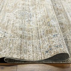 an area rug on the floor that is not clean and ready to be used for carpeting