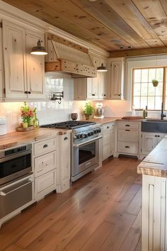 a large kitchen with white cabinets and wood flooring is seen in this image from the front view