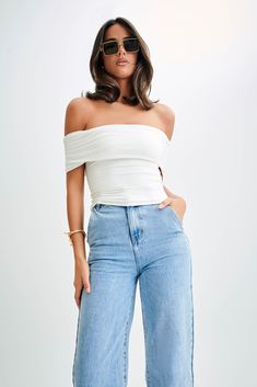 Your everyday staple. The MEENA Recycled Nylon Off-Shoulder Top seamlessly blends sustainability with style. Boasting an off-shoulder design and a ruched, foldover neckline, it adds texture and dimension to the look. With a slight bodycon fit, it flatters the silhouette while ensuring comfort. The cropped torso design introduces a playful element, making it a versatile piece suitable for various occasions. Crafted from recycled nylon, this top not only reflects a fashion-forward taste but also p Sustainable Wardrobe, Just Style, Black Tie Wedding, Beige Dresses, Off Shoulder Top, Basic Outfits, Crepe Dress, Shoulder Design, Off Shoulder Tops