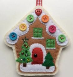 a gingerbread house ornament with buttons on it