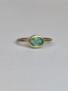 One of a kind, handmade apple green emerald ring. Stones: 1.0ct emerald Material: 9ct Solid Yellow Gold Size: M or 52mm circumference Rink Shank Width: 1,5mm Green Oval Sapphire Promise Ring, Classic Oval Tsavorite Ring, Oval Emerald Birthstone Ring In Fine Jewelry Style, Classic Oval Green Sapphire Ring, Classic Green Oval Sapphire Ring, Classic Green Sapphire Oval Ring, Classic Oval Tsavorite Emerald Ring, Oval Emerald Ring With Bezel Setting, Classic Yellow Gold Tsavorite Emerald Ring