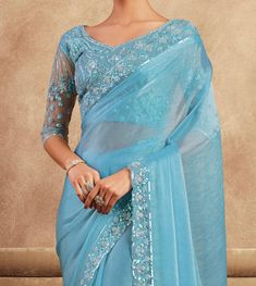 COLOR : Sky Blue FABRIC : Saree - Chiffon Silk, Blouse - Chiffon Silk & Net WORK : Resham Embroidery, Stones, Sequins, Lace BorderOCCASION : Wedding, Engagement, Party Wear, Festival, Sangeet NOTE : The outfit includes blouse and saree only. Petticoat is not included. READY-TO-WEAR : No STITCHING : Available as semi-stitched fabric, can be stitched using standard size option (+$30). Note: There might be a slight color variation due to lighting and flash used during photoshoot. The bright shade s Blue Bollywood Blouse For Formal Occasions, Blue Bollywood Formal Blouse Piece, Blue Bollywood Style Formal Blouse Piece, Festive Light Blue Blouse Piece For Party, Festive Light Blue Blouse For Party, Festive Blue Embroidered Fitted Fabric, Festive Light Blue Party Blouse, Fitted Blue Blouse Piece With Intricate Embroidery, Embroidered Blue Blouse Piece For Party