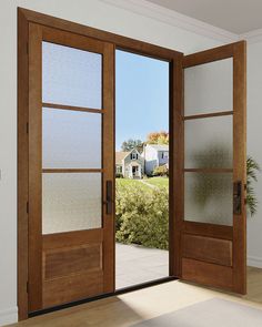 an open wooden door with frosted glass