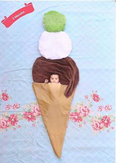 an ice cream cone with three different toppings on it, and the top one has a doll in it