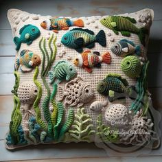 a crocheted pillow with sea animals on it