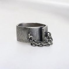 🎄Please order by December 10th to ensure the best chance for you to receive your item before Christmas!🎄 Featuring a unique, open-ended design with an attached chain detail, this ring exudes an edgy, industrial vibe. The oxidized silver finish adds depth and character, making it a perfect accessory for those who embrace a darker aesthetic.  Whats Included: 1 x Ring  Key Features: *Asymmetrical Design: Creates a striking, unconventional look *Chain Detail: Adds a touch of industrial-inspired ed Modern Sterling Silver Chain Ring As Gift, Modern Silver Chain Ring For Gift, Modern Open Chain Ring Gift, Modern Open Chain Ring As Gift, Stainless Steel Rings With Adjustable Chain For Gift, Silver Open Chain Ring For Gift, Minimalist Stainless Steel Chain Ring As Gift, Modern Ring With Adjustable Chain For Gift, Adjustable Chain Open Ring For Gift