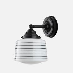 a black and white wall light on a white background with no one in the photo