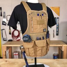 a mannequin wearing a tool belt with tools in it's back pocket