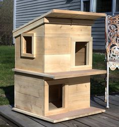 a bird house sitting on top of a wooden deck