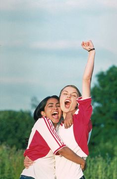 two young women are hugging and having fun