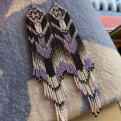 This show stopping pair of beaded earrings by Susan Keltner, a Cree descendant, will make any outfit shine! Treat yourself, or gift the pair to a partner, a family member, or a friend, the holidays are right around the corner😉! Earrings measure at approximately 8 (US)inches from hook to end. Artisan Purple Beaded Dangle Earrings, Purple Artisan Earrings With Dangling Beads, Artisan Purple Earrings With Dangling Beads, Artisan Beaded Purple Earrings, Artisan Dangle Earrings With Polished Beads, Around The Corner, Beaded Earrings, A Family, Montana