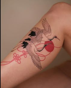 a woman's leg with a tattoo on it and a bird flying over her shoulder