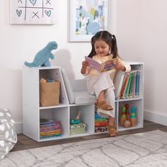 The KidKraft Bookcase with Reading Nook is popular with parents because of its clever design, sturdy construction and aesthetic appeal. Combining a cushioned seating area with bookshelves gives you two spaces in one furniture piece. Kids can store books, toys, blankets and more in the six shelves, then curl up on the three-sided angled middle section to read or rest. The two tall shelves on the sides are perfect for accommodating taller picture books. Place a lamp on the top sides for cozy light. Three gray cushions stay securely onto the base with self-adhesive strips. Available in trend-right colors to match your home's décor, the Bookcase with Reading Nook will help keep any kids room or playroom organized and neat. Crafted of premium, recyclable materials for long-lasting play Recommen Bookcase Aesthetic, Kids Storage Shelves, Toddler Storage, Childrens Shelves, Kids Clubhouse, Kids Cabinet, Storage Cabinet Shelves, Cubby Storage, Playroom Organization