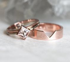 two rose gold wedding rings with a princess cut diamond