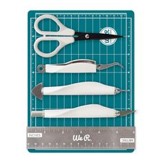 scissors and other tools on a cutting mat