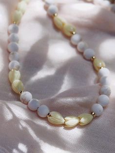 Inspired by magical Maui adventures, this beaded necklace features beads made from a blend of white turquoise and natural pikake flowers as if plucked from lush soils of the island.✦ DETAILS ✦✧ Name: Hakumele (HA koo MEH leh) - to weave a song; a poet.✧ Adjustable Length from: 20"-22".✧ 8mm Matte White Turquoise Beads.✧ Carved Resin Pikake Beads.✧ Adjustable Length from: 14kt Gold Filled Components, Extender, and Clasp.✧ All Ke Aloha Jewelry pieces come packaged thoughtfully, beautifully, and re Nature-inspired White Necklace With Natural Stones, Nature-inspired White Jewelry With Natural Stones, Adjustable White Beaded Necklace With Natural Stones, Adjustable White Nature-inspired Necklace, White Adjustable Nature-inspired Necklace, Hand-strung White Necklaces For Beach, White Single Strand Spiritual Necklace, Spiritual Single Strand White Necklace, White Spiritual Necklaces For Beach