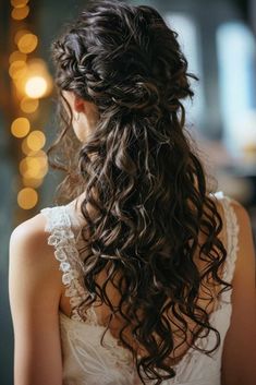 a woman with long curly hair wearing a wedding dress