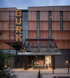 the entrance to burka is lit up at night, with an awning over it