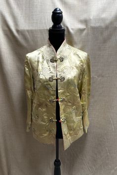 "Stunning reversible bright gold Chinese style jacket with floral print on one both sides.  Quilted cuffs, front, and pockets. Toggle closures on both sides. Mandarin collar. No tags or markings. In excellent condition. Unknown material but feels like silk or satin. Measurements (laid flat): Waist - 20\" Hips - 20\" Pit to pit - 19\" Collar opening - 5\" Shoulder to shoulder - 16\" Pit to sleeve hem - 16\" Shoulder to sleeve hem - 21.5\" Center of collar to bottom hem - 27\" Shoulder to bottom h Gold Blazer With Gold Buttons For Spring, Gold Long Sleeve Outerwear With Button Closure, Gold Long Sleeve Outerwear For Spring, Spring Outerwear With Gold Buttons And Long Sleeves, Vintage Gold Long Sleeve Outerwear, Fitted Gold Embroidered Outerwear, Gold Embroidered Long Sleeve Outerwear, Traditional Gold Outerwear For Winter, Gold Outerwear With Long Sleeves And Gold Embroidery