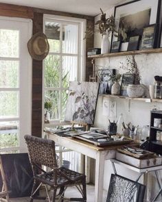 a kitchen with an old fashioned stove top oven in it's center and lots of pictures on the wall