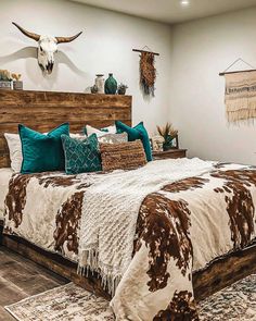 a large bed sitting inside of a bedroom on top of a wooden headboard and foot board