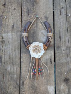 an old wooden table with a rope and flower decoration on it's center piece