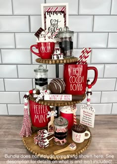 a three tiered tray with hot chocolates, marshmallows and candy canes