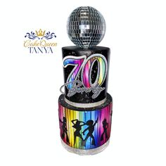 a disco ball is sitting on top of a cake with the number twenty seven in it