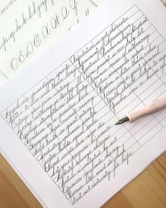 a pen sitting on top of a paper with cursive writing