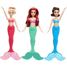 three mermaid dolls are standing in the same pose, one is holding her arms out