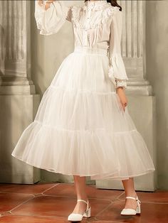 Elevate your outfit with the white 85cm daily A-line long layered petticoat. This versatile petticoat adds volume and dimension to your favorite skirts and dresses, creating a stunning A-line silhouette. The 85cm length provides ample coverage and the layered design adds a touch of whimsy to your look.  Please note that this product includes only the petticoat.  Garment Size   	 		 			Size 			Free Size 		 		 			Full Length 			85 		 		 			Waist 			58-90 White Tiered Skirt Dress With Attached Cancan, Spring Full Skirt Crinoline Petticoat, White Ruffled Skirted Petticoat, White Flowy Ruffled Petticoat, White Ruffled Petticoat With Flowy Fit, Voluminous Skirted Petticoat With Ruffles, Spring Wedding Petticoat With Ruffled Skirt, Spring Wedding Ruffled Petticoat, White Ruffled Skirt Petticoat