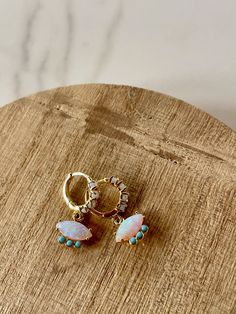 This listing is for one pair of stunning gold huggie earrings. Made with lab made opal and turquoise, they're lightweight, unique, and sure to catch everyones' attention. The posts are sterling silver, plated in 14k gold. They're hypoallergenic and comfortable to wear all day long. Turquoise Huggie Earrings, Huggie Earrings Gold, Opal Birthstone, Creating Jewelry, Gold Gold, Summer Jewelry, Huggies Earrings, Resin Jewelry, Metal Jewelry