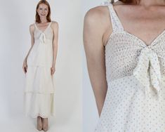 Elegant Roberta smocked prairie dress. Tailored bodice with high waist and shoulder tie spaghetti straps. Fitted waist with layered long draped skirt. Lightweight off white floral cotton blend material. Dress is lined and zips up the back. size estimate: S shoulders: tie bust: 28"-37" waist: 25"-29" hips: 45" total length: 55.5" Model is 5'9" and measures 32" bust, 25" waist, 34" hips. Belts/accessories are not included unless noted in the description Summer Prairie Dress With Ruffles For Gatherings, Summer Prairie Dress With Smocked Bodice For Gatherings, Spring Garden Party Prairie Dress With Smocked Bodice, Spring Daywear Prairie Dress With Smocked Back, Spring Prairie Dress With Smocked Back For Daywear, Spring Prairie Dress For Daywear, Spring Prairie Daywear Dresses, Summer Cottagecore Prairie Dress For Gatherings, Vintage Spring Dresses With Tie Straps