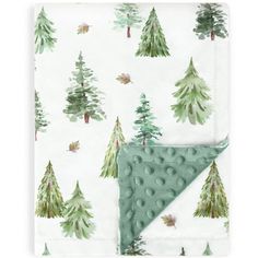 a green and white blanket with trees on it