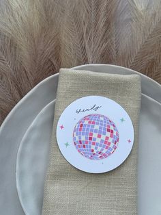 a plate with a napkin on it and a place setting in front of some feathers