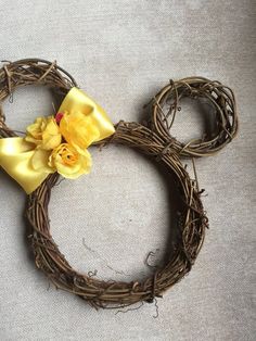 a mickey mouse head made out of twigs with a yellow bow on it's head