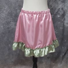 "Super cute and flirty A-line mini skirt made from Rose Pink poly satin with a ruffled bottom in Sage Green poly satin. This is a one of a kind item (OOAK) as I only had enough of each fabrics to make the one skirt. Size Large, elastic waist will fit waists from 34-39 inches (86.5-99 cm) . 18 inches in length BLOUSE AND WAIST CINCHER ARE NOT INCLUDED. THIS IS A FINISHED ITEM AND WILL SHIP WITHIN 48 HOURS OF COMPLETED PAYMENT. ✿This piece will be handmade entirely by me from design to completion Cute Mini Skort For Party, Cute Mini Skort For Parties, Cute Mini Length Skort For Party, Cute Party Skort In Mini Length, Cute Ruffled Skort For Party, Cute Party Skort With Ruffles, Fitted Ruffled Mini Skirt For Cosplay, Fairy Kei Fitted Mini Skirt, Fitted Mini Skirt In Fairy Kei Style