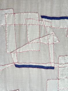 an old quilt with red, white and blue stitchs