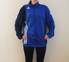 ADIDAS Vintage Sport jacket. Bright blue Adidas windbreaker. Tracking jacket with zipper at front and two side pockets. Vintage activewear Adidas jacket. Adidas White Stripes. Label size: L  EU 42/44 Measurements (taken while lying flat): Chest: 54cm / 21" Bottom line: 46cm / 18" Shoulder: 13cm / 5" Sleeve: 68cm / 27" Lenght: 70cm / 27.5" Good vintage condition. Please check measurements to insure a proper fit. Remember to allow yourself some extra room for movement.  If you have any questions feel free to ask. SHIPPING * I ship worldwide via Priority mail (Latvijas Pasts) from Latvia (EU). * I ship from Europe, so please allow 2 to 3 weeks for the package to arrive if you live overseas. * Europe 5 - 10 business days. D34 Adidas Vintage Jacket, Vintage Activewear, Blue Windbreaker, Jacket Adidas, Adidas Windbreaker, Adidas Vintage, Sport Jacket, Jacket Vintage, Vintage Sports