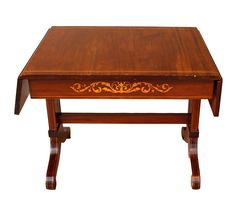 a small wooden table with an intricate design on the top and bottom edge, against a white background