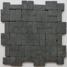 a close up of a wall made out of small square blocks with one block in the middle