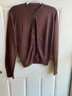 This authentic 1970's vintage brown cardigan sweater is in good condition with a little pilling. It is long sleeved with buttons up the front. Bust-36 inches Length-23 inches Sleeve-25 inches To see more of our vintage 1970's clothing inventory please visit our store at ChoiceRecycling.  We add new items every week. Thank you, Karmyn Vintage Long Sleeve Cardigan For Fall, Brown Buttoned Cardigan For Fall, Brown Buttoned Sweater For Winter, Vintage Brown Long Sleeve Cardigan, Brown Vintage Long Sleeve Cardigan, Classic Brown Sweater With Buttons, Brown Fitted Sweater With Button Closure, Fitted Brown Sweater With Button Closure, Brown Long Sleeve Sweater For Layering