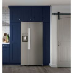 a stainless steel refrigerator in a blue kitchen