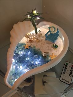 a white shell shaped tray filled with toys and lights