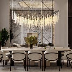 an elegant dining room with chandelier and white chairs in front of the table