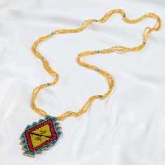 Trendy and tribal-inspired, the Mayan Pyramid Beaded Pendant Necklace makes a bold statement. Perfect for pairing with whites or denim for a great boho look. Made by women artisans of La Casa in Guatemala. Since 2000, La Casa Cotzal has designed a range of Guatemalan handcrafted pieces produced by artisan communities throughout the country. Mayan women traditionally have been backstrap loom weavers, but increasingly they are learning to use pedal looms as well. In traditional Guatemalan weaving, the two main specialized techniques are ikat and supplementary weft brocade. Artisans at La Casa are versed in both weaving techniques as well as in intricate bead work. The work provided by La Casa is vital to the women's families and communities. Glass beads & cotton thread Pendant: 3.25" H x 2" Guatemalan Weaving, Mayan Women, Paw Print Jewelry, Spirit Clothing, Backstrap Loom, Ribbon Jewelry, Fair Trade Jewelry, Printed Jewelry, Beaded Pendant Necklace