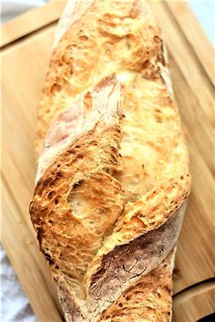 a loaf of bread sitting on top of a wooden cutting board