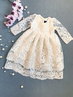 Ivory organic cotton lining and ivory gorgeous lace baby girl's christening/ baptism/flower girl gown.  3 pearl buttons closure at the back. Two-layered lace skirt, looks gorgeous when cascades while holding the baby.  Please contact the shop owner regarding any specific measurements or inquiries.  Matching bonnet - https://www.etsy.com/ca/listing/558391374/ivory-christening-bonnet-ivory-lacy Matching headband - https://www.etsy.com/ca/listing/577338309/baby-girl-headband-lace-headband-infant Ma Outfit For Wedding, Blessing Gown, Girls Baptism Dress, Flower Girl Gown, Blessing Dress, Beautiful Lace Dresses, Baptism Gown, Christening Gown